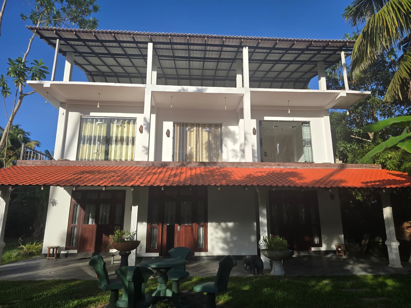 The Riverview Villa in bright afternoon light, framed by tropical greenery